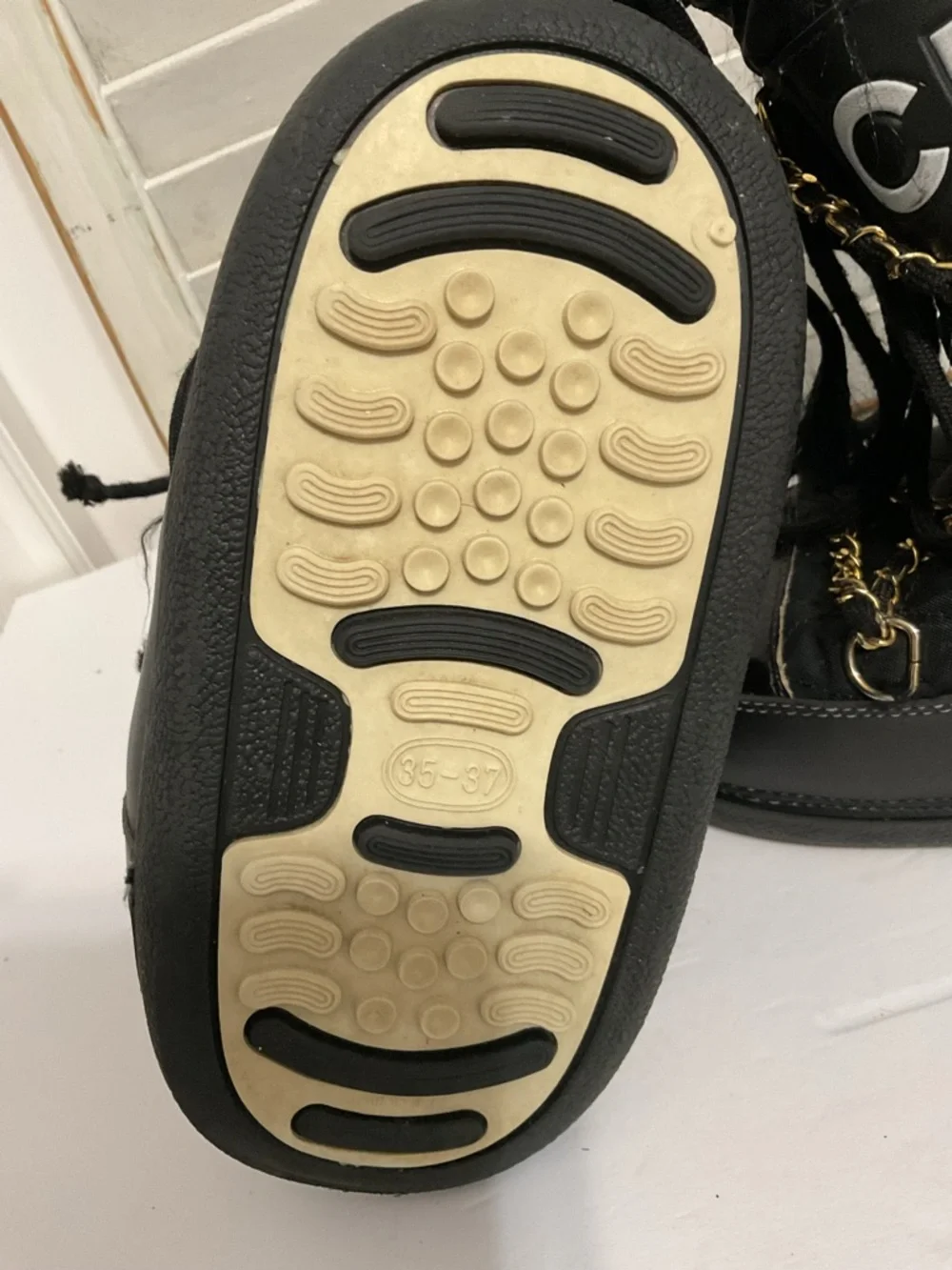 CHANEL Black and Gold Quilted Winter Lace-Up Boots